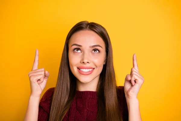 Close up photo of charming lady looking up pointing promo at copy space wearing marsala jumper isolated over yellow background — Stock Photo, Image