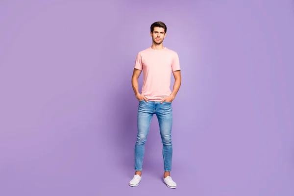 Full length body size view of his he nice attractive fit peaceful content guy wearing pink tshirt standing straight holding hands in pockets isolated on violet purple lilac pastel color background — Stock Photo, Image