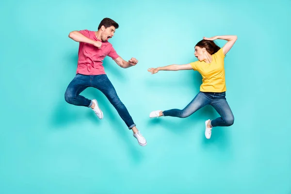 Full length body size view of nice attractive sportive crazy strong couple having fun fighting in air contest discount isolated over bright vivid shine vibrant green turquoise background — стоковое фото