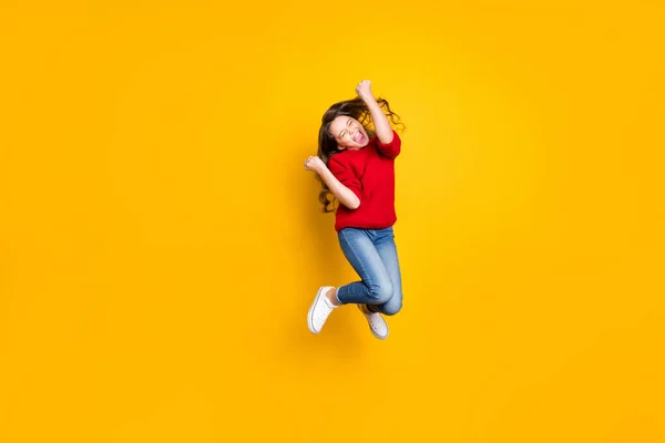 Full size photo of delighted crazy child wavy curly hair lucky kid win contest raise fists scream yeah wear stylish trendy pullover white sneakers isolated over yellow color background — Stock Photo, Image