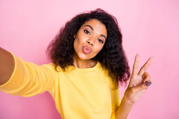Close-up photo portrait of coquettish pretty nice lovely dreamy with gorgeous face curly hairstyle blogger taking selfie showing v-sign wearing bright color yellow pullover isolated background — Stock Photo, Image