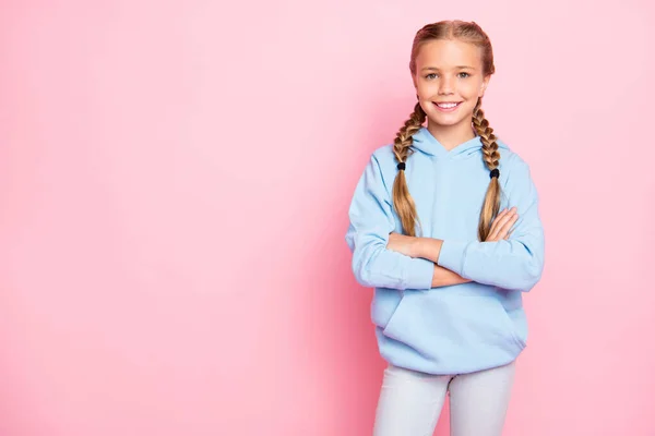 Foto van vrolijke positieve soort vriendelijk schattig meisje staat vol vertrouwen met armen gekruist in de buurt van lege ruimte te vervullen met advertenties geïsoleerd over pastel kleur achtergrond — Stockfoto