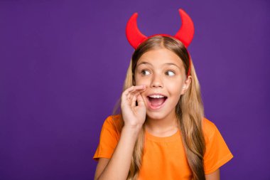 Photo of funny little lady headband horns on head sharing rumours wit classmates chatterbox october party wear orange t- shirt isolated purple color background clipart