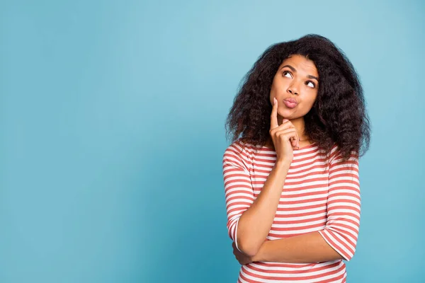 Photo of pretty dark skin lady looking empty space wondered think over philosophy questions wear casual striped sweater isolated pastel blue color background — Stock Photo, Image