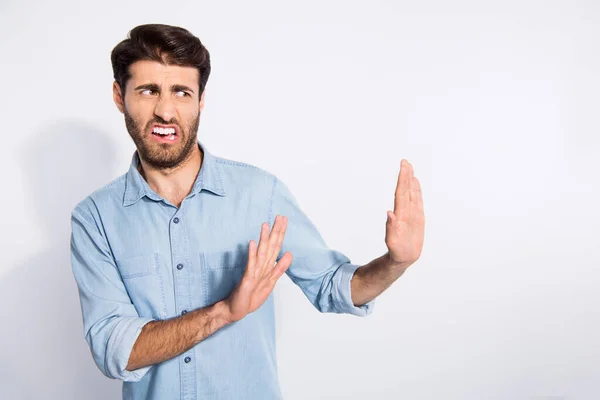 Foto de tipo multiétnico increíble buscando espacio vacío con parada de asco con el movimiento de brazos a él usar camisa vaquera casual aislado fondo de color blanco — Foto de Stock