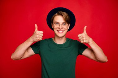 Portrait of positive cheerful imposing guy show thumb up recommend sales discounts give feedback about ads wear casual lifestyle outfit isolated over red color background clipart