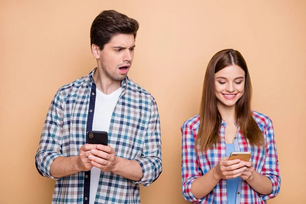 Retrato dele ele ela ela agradável atraente encantador alegre casal vestindo camiseta marcada criando smm post como seguir cara espreitando isolado sobre fundo cor pastel bege — Fotografia de Stock