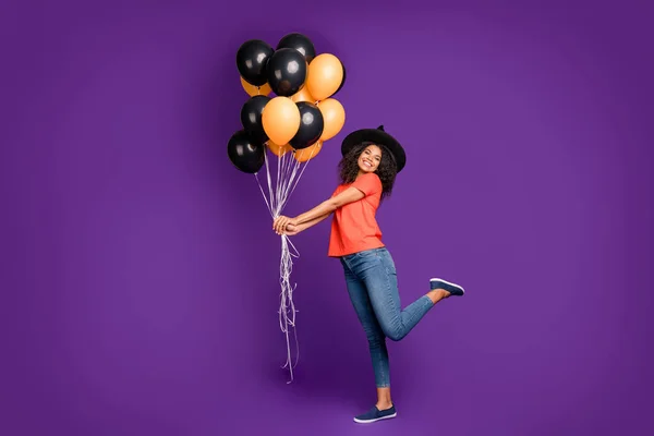 Ganzkörpergröße Seitenprofil-Foto von fröhlich positiv niedlich hübsch charmant hübsch mädchenhaft Youngster halten Luftballons mit Helium gefüllt tragen Jeans-Jeans lächelnd zahnhaft spielende freundliche Hexe — Stockfoto