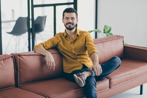 Foto de chico guapo en increíble estado de ánimo de trabajo en el amor con su trabajo escuchar jefe de arranque explicando sentarse sofá de la oficina en el espacio de trabajo moderno en interiores —  Fotos de Stock