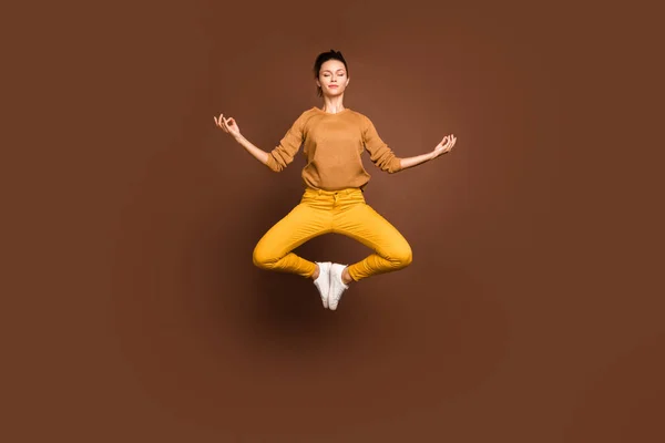 Full length body size photo of jumping concentrated girlfriend having torn away from this world lost in dreams meditating clearing her chakra isolated over brown color pastel background — Stockfoto