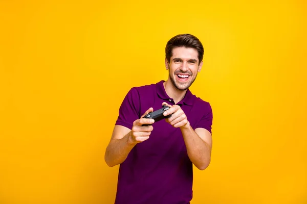 Portrait of his he nice attractive cheerful cheery glad guy playing cool new videogame online isolated over bright vivid shine vibrant yellow color background — Stock Photo, Image