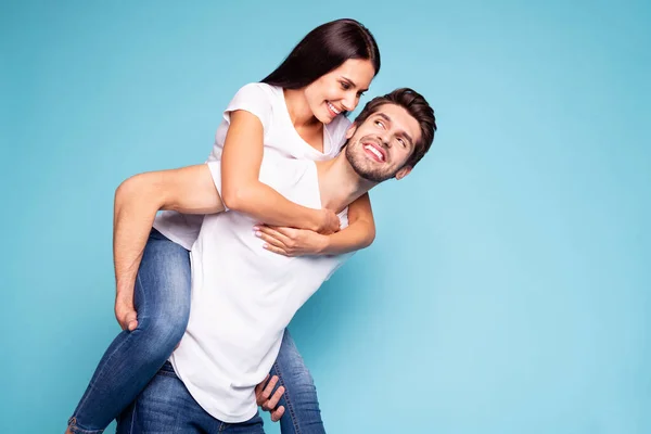 Portrait of his he her she nice attractive lovely sweet cheerful cheery couple soulmate piggybacking having fun isolated on bright vivid shine vibrant blue turquoise background — Stock Photo, Image
