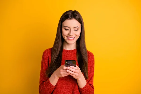 Foto van vrolijke schattige prachtige aantrekkelijke jongere holding telefoon met handen glimlachend tandheelkundig bladeren door multimedia geïsoleerde levendige kleur achtergrond — Stockfoto