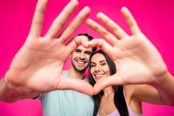Photo of amazing guy and lady making heart figure with arms located faces inside of it wear casual outfit isolated pink color background — Stock Photo, Image