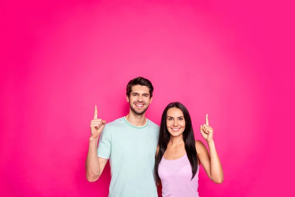Photo of funny couple guy and lady indicating fingers to empty space advising black friday shopping wear casual clothes isolated vivid pink color background — Stock Photo, Image