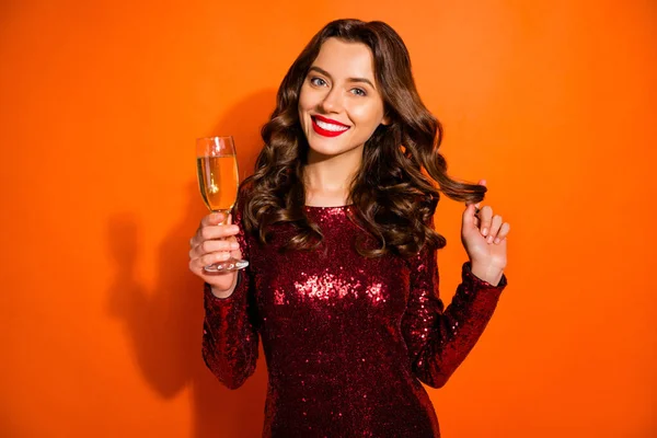 Close-up portrait of her she nice attractive pretty girlish feminine cheerful wavy-haired girl drinking champagne playing with curls isolated over bright vivid shine vibrant orange color background — ストック写真