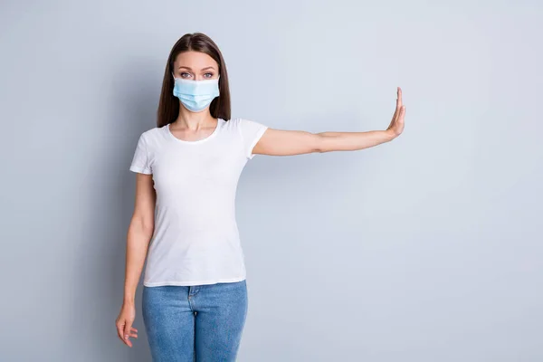 Photo of serious lady keep social distance avoid people contacting hospital examination raise arm side epidemic quarantaine wear protect face mask t-shirt isolated grey color background — Stockfoto