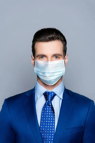 Vertical close-up view portrait of his he nice attractive chic classy guy ceo boss chief wearing medical gauze mask sickness illness disease prevention isolated over grey pastel color background — Stock Photo, Image