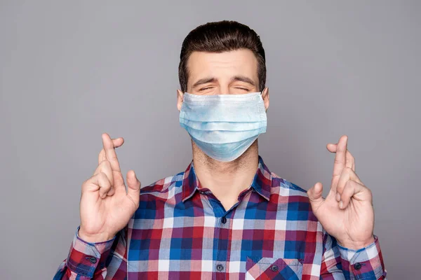 Close-up portrait of his he nice attractive dreamy hopeful guy wearing checked shirt crossed fingers praying decontamination sickness prevention isolated over grey pastel color background — Stock Photo, Image