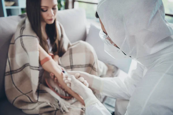 Photo of sick ill patient lady guy doc make injection sample probe vein blood covid antibodies research vaccine elastic harness on hand wear uniform suit protection quarantine indoors — Stock Photo, Image