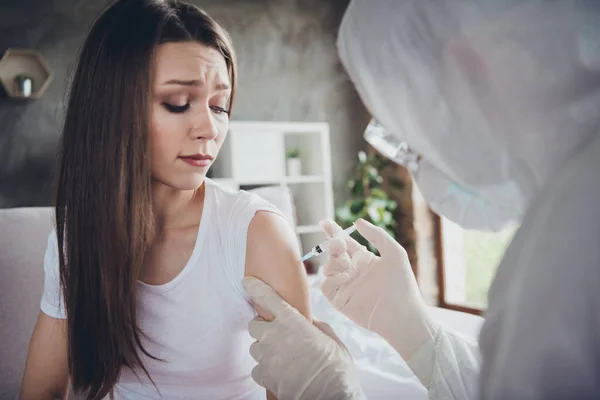 Photo of young sick crying terrified patient lady feel bad unwell call emergency doc virologist flu cold covid injection hand shoulder medication help wear gloves protective uniform indoors — Stock Photo, Image