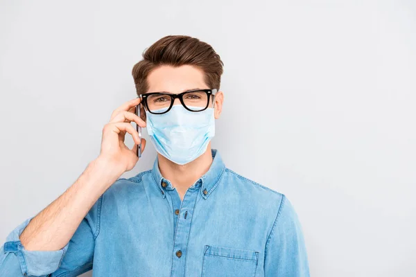 Successful smart businessman in glasses blue shirt wear medical safety face mask talking with clients on phone, corona virus prevention protection distance remote work concept — Stock Photo, Image
