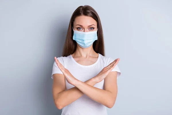 Photo of pretty serious lady avoid people crowd contacting hospital examination raise crossed arms keep one meter distance wear protect face mask isolated grey color background — Stock Photo, Image