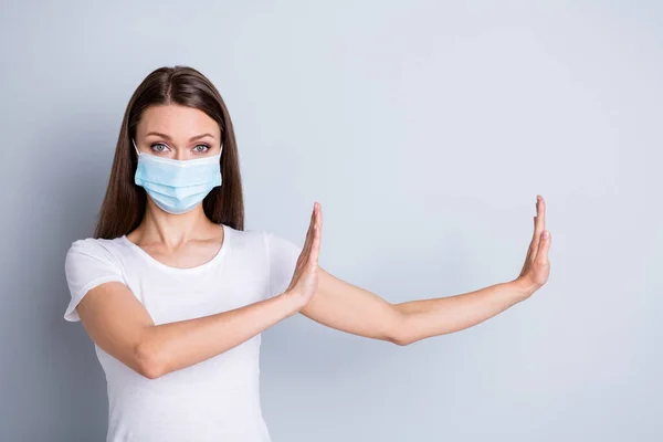 Photo of pretty serious lady keep social distance avoid people contacting hospital examination raise arms side copyspace empty space wear protect face mask isolated grey color background — Stockfoto