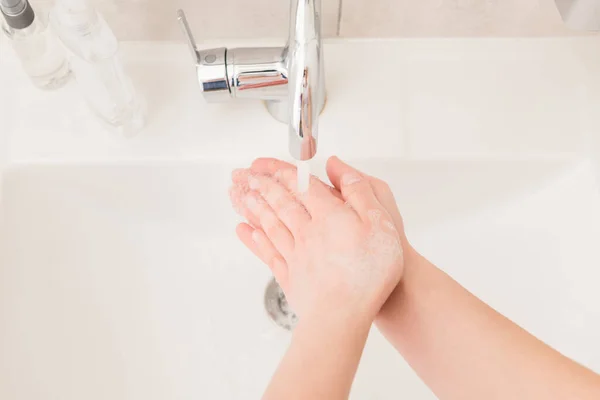 High angle above closeup photo lady wash arms sink under hot water flow stream rub soap bubbles for thirty seconds viral prevention sanitation concept bathroom indoors — Stock Photo, Image