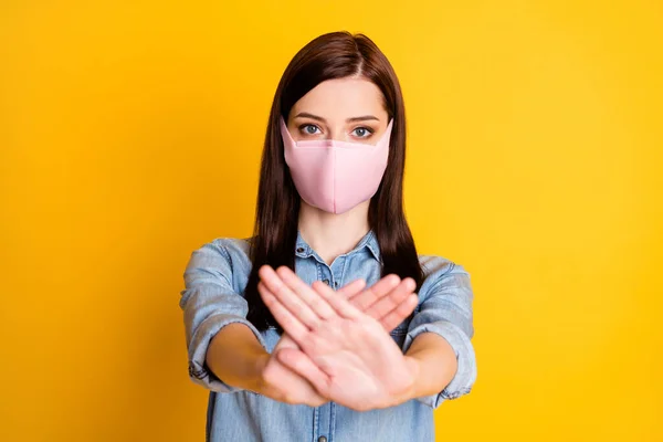 Portret poważnej dziewczyny pokazać znak stop gest ostrzec ludzi pobyt w domu nosić piękne medyczne maski dżinsy koszulka izolowane na jasny połysk kolor tła — Zdjęcie stockowe