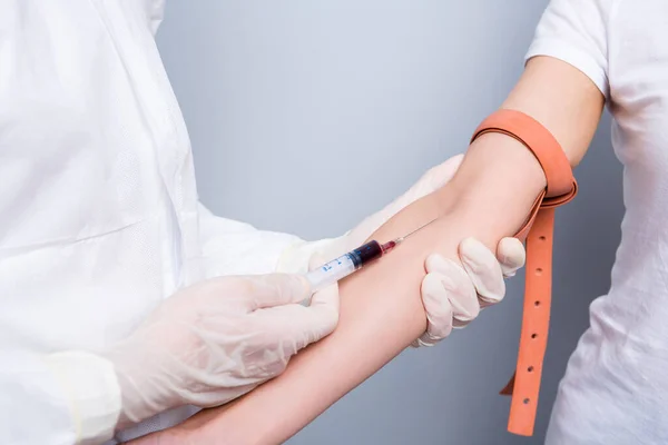 Cropped closeup photo of patient lady guy doc inject sample vein blood covid antibodies research vaccine elastic harness wear uniform suit protection isolated grey color background — Stock Photo, Image