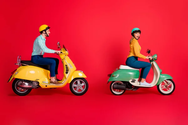 Profiel side view of her she his he nice attractive positive cheery couple driving vehicle travel having fun time isolated on bright vivid shine vibrant red color background — Stockfoto