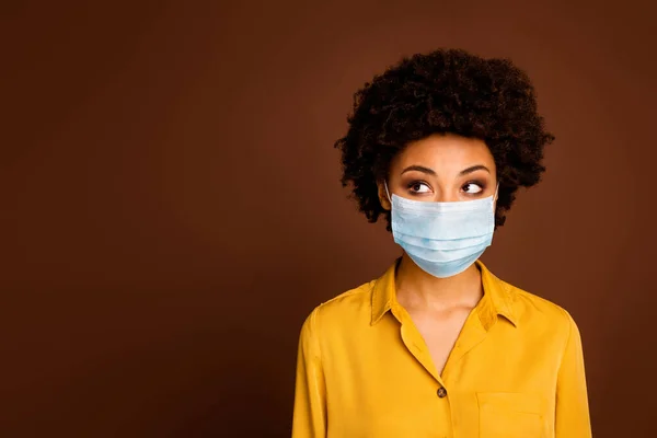 Close-up portrait of her she minded thoughtful dark skin wavy-haired lady wearing yellow shirt mask concept sickness illness disease thinking therapy prevention tips isolated brown color background — Stock Photo, Image