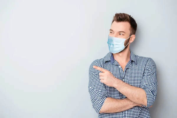 Portret van zijn hij aantrekkelijke inhoud man dragen herbruikbare gaas masker gezondheidszorg demonstreren kopieerruimte info poster plakkaat geïsoleerd over grijs licht pastel kleur achtergrond — Stockfoto