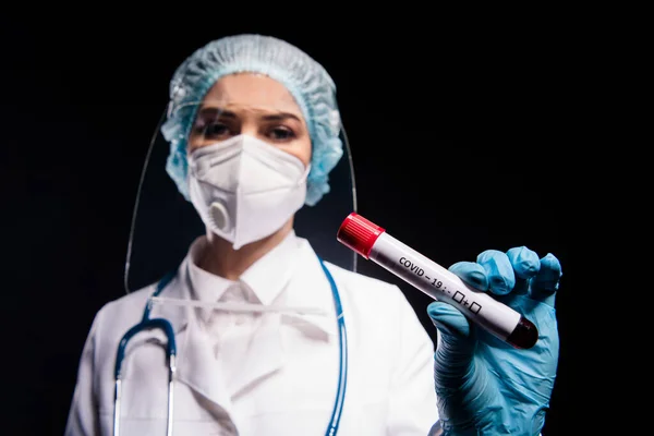 Close up photo of virology doc clinic hold blood probe tube showing patient negative test result good news wear coat mask face plastic protection shield surgical cap isolated black background — Zdjęcie stockowe
