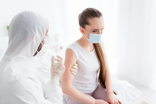 Photo of young sick patient lady unwell call emergency doc virologist flu cold covid injection hand shoulder medication help wear latex gloves protective uniform bedroom indoors — Stock Photo, Image