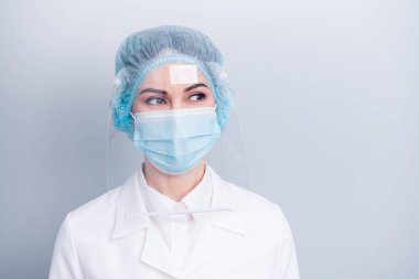 Closeup photo of attractive virologist doctor lady surgery operation save life look side dreamy wear medical gown coat mask facial plastic protect surgical cap isolated grey background clipart