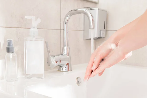 30 seconds rule. Closeup cropped photo lady wash arms sink hot water rub soap between fingers corona virus prevention sanitation concept responsible useful habit bathroom indoors