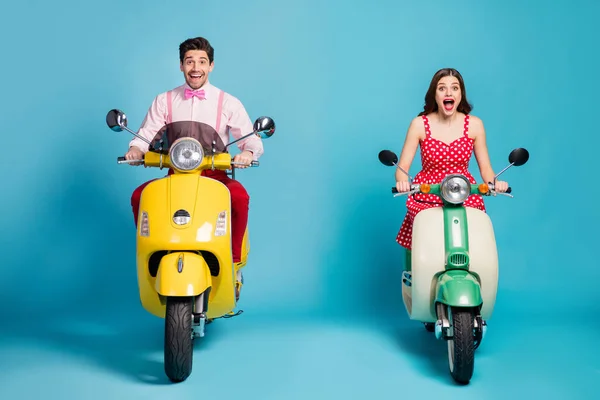 Полная длина фото шокированной жены муж мотоциклисты ездить на электрическом скутере впечатлен крик Омг носить красные пунктирные юбки розовая рубашка изолированы на синем фоне цвета — стоковое фото