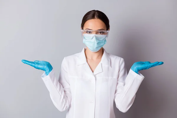 Foto de virologist doc lady experienced professional hold two open palms examination vaccine project comparison wear gloves glasses facial mask uniform lab coat isolated grey background — Foto de Stock