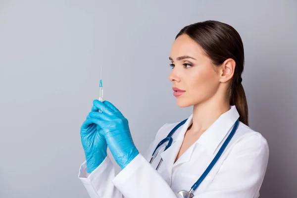 Κοντινό πλάνο φωτογραφία του επαγγελματία γιατρού σοβαρή νοσοκόμα προετοιμάσει τον εμβολιασμό του ασθενούς σύριγγα αντιβιοτικό φορούν γάντια λατέξ ιατρική ομοιόμορφη εργαστηριακή ποδιά στηθοσκόπιο απομονωμένο γκρι φόντο — Φωτογραφία Αρχείου