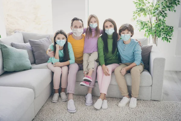 좋은 건강 한 가족 개념 사람들은 3 명의 십 대 아이들을 안고 앉아서 거즈 안전 마스크를 쓰고 — 스톡 사진