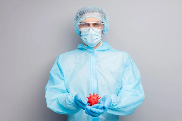 Photo of guy expert doc virology center hold covid bacteria hands vaccine research wear mask hazmat blue uniform surgical cap suit plastic facial goggles isolated grey color background — Zdjęcie stockowe