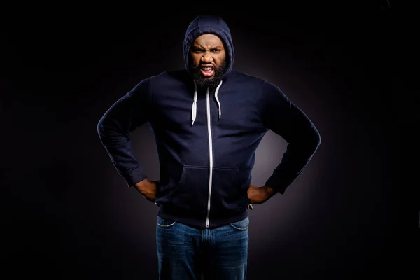 Photo of irritated annoyed furious afro american guy put hands waist angry with no solidarity african community wear sweater denim jeans isolated over black color background