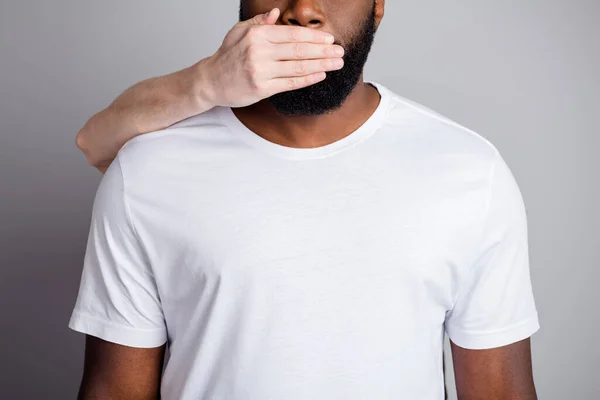 Do not speak. Cropped photo of african american guy unfairly society shut up black race citizens need help white skin arm close his mouth danger lawlessness isolated grey color background