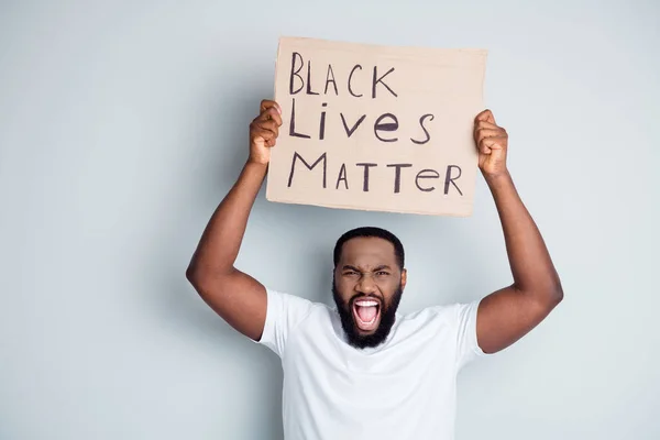 Photo of crazy screaming dark skin afro race guy protester placard against black citizens social lawlessness call government stop murder black people problem isolated grey color background