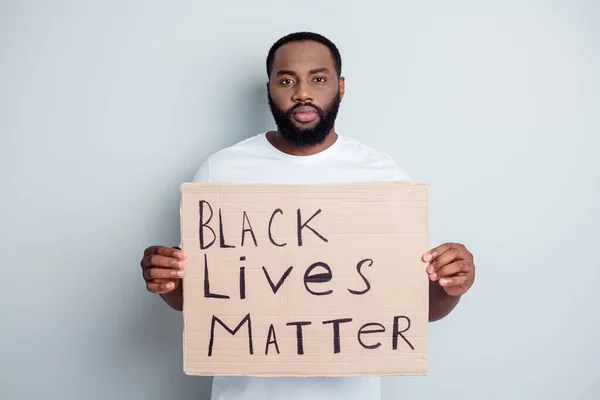 Black lives matter. Photo of serious disappointed dark skin african protester placard community against black citizens lawlessness stop murder people concept isolated grey color background