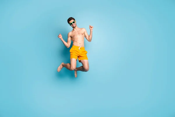 Full längd kroppsstorlek bild av hans han trevlig attraktiv glad glad glad kille i simning shorts hoppa ha kul isolerad på ljusa levande glans levande grön blå turkos färg bakgrund — Stockfoto