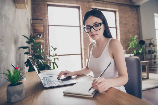 Profile side photo of focused assistant girl work remote laptop have online seminar meeting boss write tips copybook star-up progress presentation sit desktop chair in comfy home office house — Stock Photo, Image