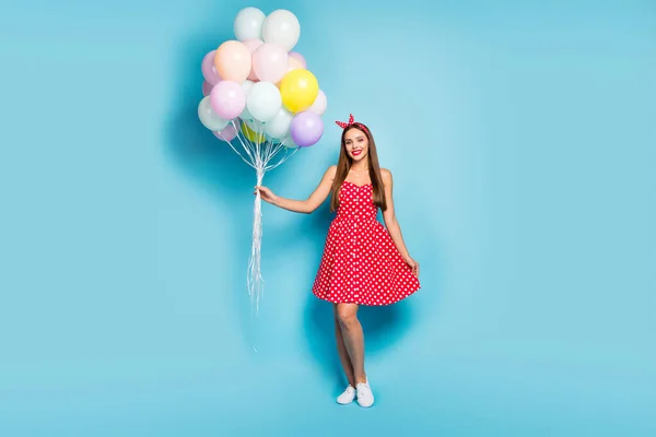 Full length body size view of nice attractive lovely pretty winsome cheerful straight-haired girl having fun holding air balls isolated on bright vivid shine vibrant blue color background — стоковое фото